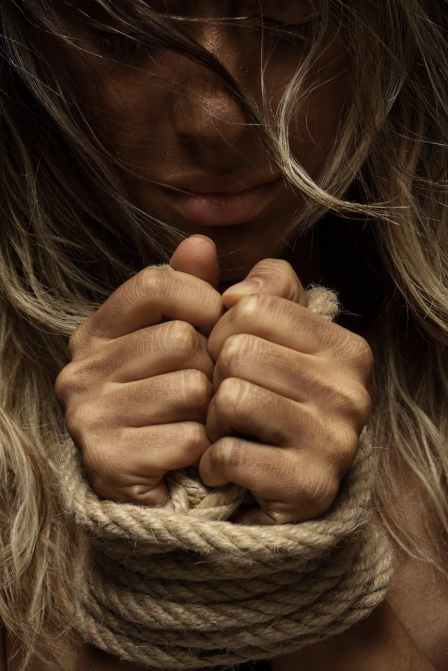 close up photo of woman with her hands tied with rope